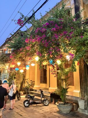 Street in Hoi An, Vietnam with a motorcycle parked outside
