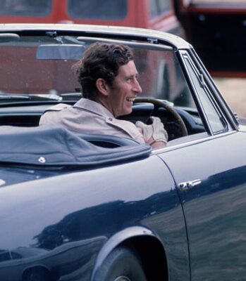 Prince Charles arrives in his Aston Martin car to attend a polo match at Windsor Great Park in 1975. Photo by Anwar Hussein/Getty Images